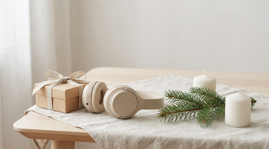 Personalisiertes Weihnachtslied als Geschenk: Geschenkbox, Kopfhörer und Tannenzweig auf hellem Leinen